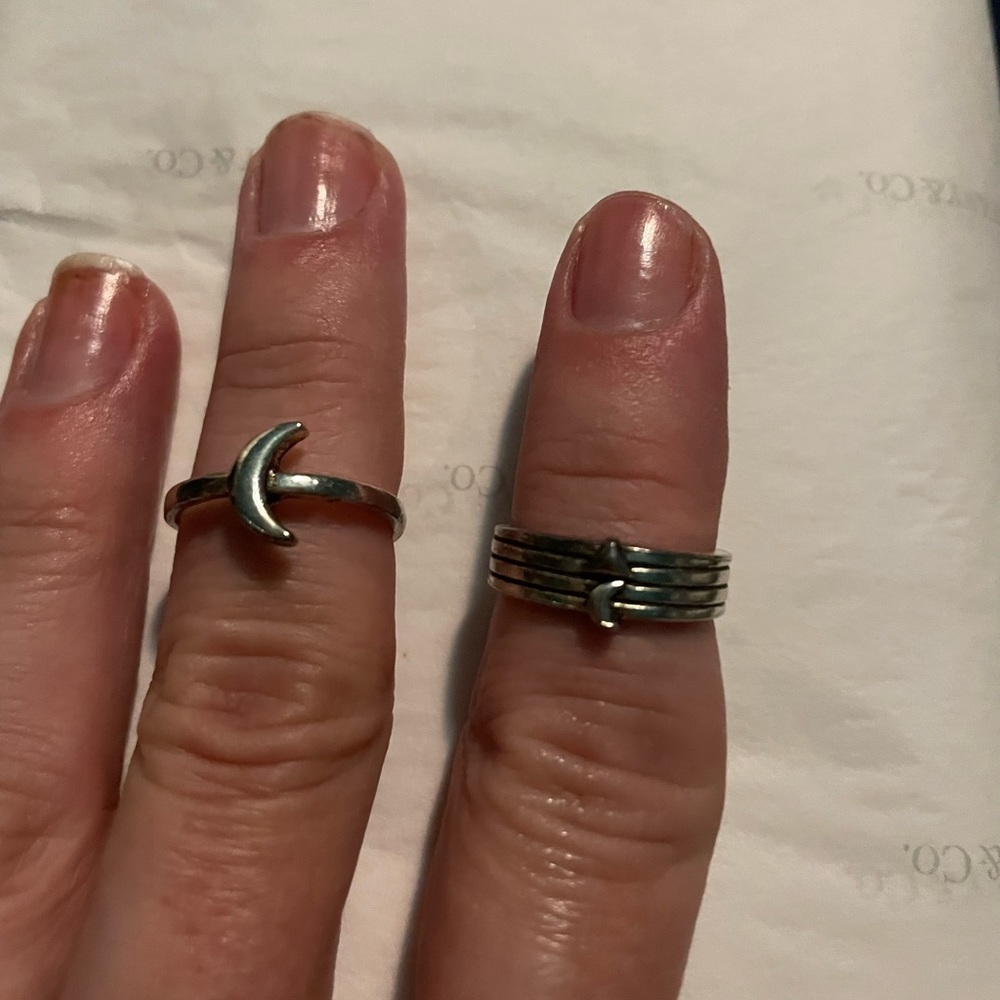 Silver colored rings. One w/moon and one w/tiny moon & tiny triangle. NWOT
